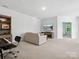 Spacious living room featuring light colored walls, carpeted floor, and open doorway to a bedroom at 2467 Chatham Dr, Fort Mill, SC 29707