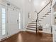 Welcoming foyer with hardwood floors, staircase, and natural light at 2467 Chatham Dr, Indian Land, SC 29707