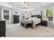 Spacious primary bedroom with tray ceiling, plush carpet, and lots of natural light at 2467 Chatham Dr, Indian Land, SC 29707