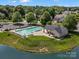 Community pool featuring lounge chairs, picnic tables, and a lake view at 2467 Chatham Dr, Indian Land, SC 29707