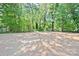 A spacious, mostly cleared backyard bordered by lush trees, offering a serene outdoor space at 2502-2504 Glendale Ave, Kannapolis, NC 28081