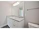 Bright bathroom featuring a double sink vanity with granite countertop and a large mirror at 2502-2504 Glendale Ave, Kannapolis, NC 28081