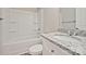 Well-lit bathroom featuring a granite countertop vanity, toilet, and a bathtub with a shower at 2502-2504 Glendale Ave, Kannapolis, NC 28081