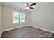 Inviting bedroom featuring a modern ceiling fan and a window providing natural light and a view of the outdoors at 2502-2504 Glendale Ave, Kannapolis, NC 28081