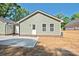 Single-story home with light green siding, white trim, and a newly installed concrete patio at 2502-2504 Glendale Ave, Kannapolis, NC 28081