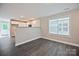 Bright living room featuring hardwood floors and an open view of the kitchen with white cabinets at 2502-2504 Glendale Ave, Kannapolis, NC 28081