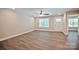 Living room with hardwood floors, ceiling fan, and natural light from the front door and window at 2502-2504 Glendale Ave, Kannapolis, NC 28081
