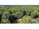 An aerial view of a cozy home nestled in a peaceful woodland setting at 2603 Mary Ave, Gastonia, NC 28052