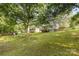 Lush backyard surrounded by mature trees and greenery, perfect for outdoor enjoyment at 2603 Mary Ave, Gastonia, NC 28052