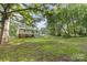 Lush backyard surrounded by mature trees and greenery, perfect for outdoor enjoyment at 2603 Mary Ave, Gastonia, NC 28052