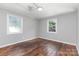 Bedroom with hardwood floors, neutral walls, and light from two windows at 2603 Mary Ave, Gastonia, NC 28052