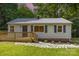 Charming home featuring a well-maintained yard, wooden deck, and stone pathway to the front door at 2603 Mary Ave, Gastonia, NC 28052