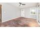 A bright, empty living room with refinished wood floors, ceiling fan and access to the deck at 2603 Mary Ave, Gastonia, NC 28052