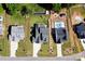 Stunning aerial view of three homes with lush green lawns, inground pools, playground and long driveways at 262 Country Lake Dr, Mooresville, NC 28115