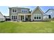 Exterior view of a home with a patio, lawn, and well-maintained landscaping at 262 Country Lake Dr, Mooresville, NC 28115