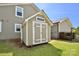 Backyard storage shed with a beige exterior and white trim at 262 Country Lake Dr, Mooresville, NC 28115