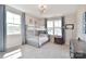 Bright bedroom featuring a bunk bed, two windows, gray walls, and a modern chandelier at 262 Country Lake Dr, Mooresville, NC 28115