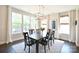 Bright dining room with large windows, chandelier, and a dark wood dining table at 262 Country Lake Dr, Mooresville, NC 28115
