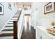 Bright entryway featuring a staircase, hardwood floors, and neutral wall decor at 262 Country Lake Dr, Mooresville, NC 28115