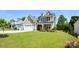 Charming two-story home with a well-manicured lawn, attached two-car garage, and inviting front porch at 262 Country Lake Dr, Mooresville, NC 28115