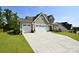 Two-story home with a well-manicured lawn and a spacious driveway leading to an attached two-car garage at 262 Country Lake Dr, Mooresville, NC 28115
