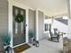 Inviting front porch with rocking chairs, decorative planters, and a welcoming wreath on the front door at 262 Country Lake Dr, Mooresville, NC 28115