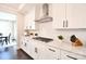 Modern kitchen featuring white cabinets, stainless steel range hood, and subway tile backsplash at 262 Country Lake Dr, Mooresville, NC 28115