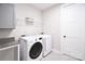 Functional laundry room equipped with a modern washer, dryer, and storage shelf at 262 Country Lake Dr, Mooresville, NC 28115