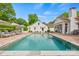 Beautiful backyard with a pool, mature trees, and comfortable lounge chairs create a relaxing and private setting at 2900 Wickersham Rd, Charlotte, NC 28211