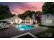 Expansive backyard with a pool, jacuzzi, lush greenery, and an outdoor seating area, perfect for relaxing at 2900 Wickersham Rd, Charlotte, NC 28211