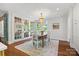 Bright dining room with hardwood floors, chandelier, and doors leading to the outdoor space at 2900 Wickersham Rd, Charlotte, NC 28211
