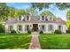 Charming white brick home featuring dormer windows, lush lawn, and a brick walkway leading to the front door at 2900 Wickersham Rd, Charlotte, NC 28211