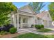 Charming white brick home featuring a covered front porch with stately columns and a welcoming bench at 2900 Wickersham Rd, Charlotte, NC 28211
