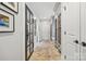 Hallway featuring herringbone brick floors, a glass-paned door, and custom built-in storage and seating at 2900 Wickersham Rd, Charlotte, NC 28211