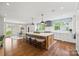 Bright, open kitchen featuring a large island with seating, white cabinets, and hardwood floors at 2900 Wickersham Rd, Charlotte, NC 28211
