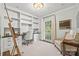 Well-lit home office with built-in shelves, a large window, and a comfortable seating area at 2900 Wickersham Rd, Charlotte, NC 28211