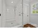 Elegant glass enclosed shower with white tile, mosaic floor, bench and bright light at 2900 Wickersham Rd, Charlotte, NC 28211