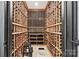 Spacious wine cellar with ample storage, custom wooden racks, and a brick floor at 2900 Wickersham Rd, Charlotte, NC 28211