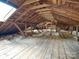 Unfinished attic space featuring exposed wooden beams and a skylight at 3128 Country Club Dr, Charlotte, NC 28205