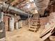 Unfinished basement area with concrete flooring and exposed brick walls at 3128 Country Club Dr, Charlotte, NC 28205