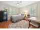 Cozy bedroom with hardwood floors, two windows, and a work desk at 3128 Country Club Dr, Charlotte, NC 28205