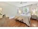 Bedroom with wood floors, natural light, and well-appointed furnishings at 3128 Country Club Dr, Charlotte, NC 28205