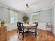 Cozy dining room featuring hardwood floors, a chandelier, and lots of natural light at 3128 Country Club Dr, Charlotte, NC 28205