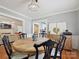 Elegant dining room with a wooden table, chandelier, and views into the living room and updated kitchen at 3128 Country Club Dr, Charlotte, NC 28205