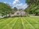 Well-maintained home with a manicured lawn and classic architectural details, creating a welcoming curb appeal at 3128 Country Club Dr, Charlotte, NC 28205