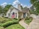 Charming home features manicured landscaping, a welcoming entrance, and an American flag waving proudly at 3128 Country Club Dr, Charlotte, NC 28205