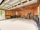 Spacious garage with exposed wood beams, featuring ample storage and potential for a workshop or hobby area at 3128 Country Club Dr, Charlotte, NC 28205