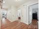 Hallway with hardwood floors and classic white doors leading to rooms at 3128 Country Club Dr, Charlotte, NC 28205