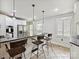 Kitchen with stainless steel appliances, granite countertops, and three bar stools at the breakfast bar at 3128 Country Club Dr, Charlotte, NC 28205