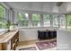 Bright sunroom converted into a laundry room with ample windows and natural light at 3128 Country Club Dr, Charlotte, NC 28205